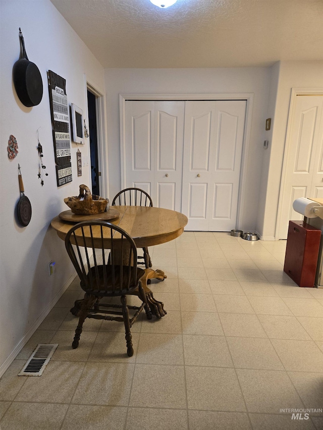 dining area featuring baseboards and visible vents