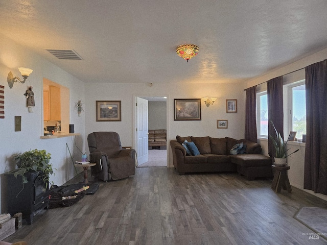 living room featuring dark wood finished floors and visible vents