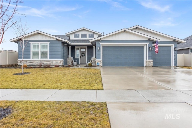 craftsman house with a garage, concrete driveway, a front lawn, and stone siding