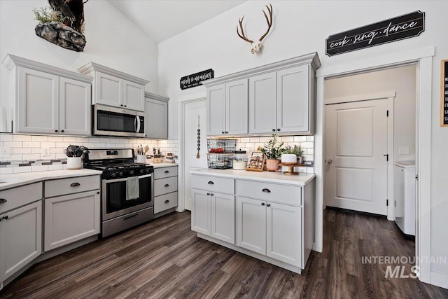 1418 N Birch St, Jerome, ID 83301 - kitchen featuring appliances with stainless steel finishes, backsplash, high vaulted ceiling, light countertops, and dark wood-style flooring
