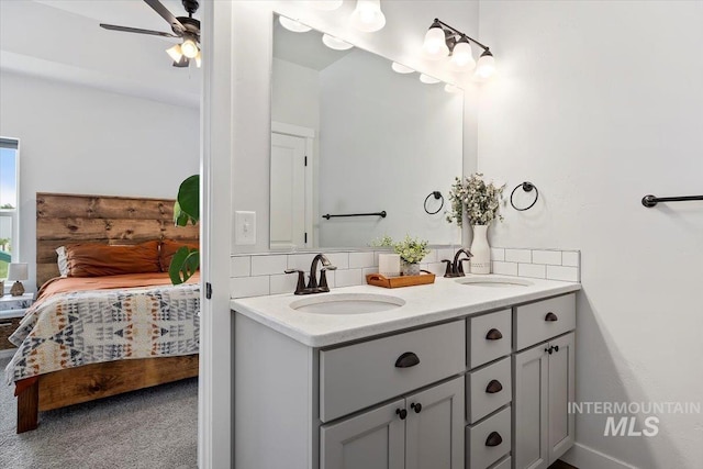 bathroom with ceiling fan, backsplash, and vanity