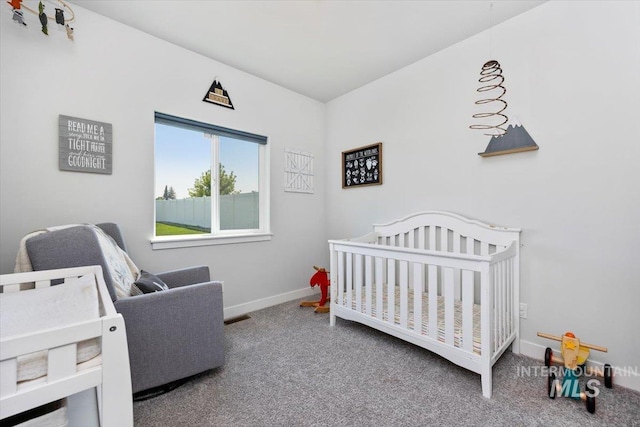 bedroom with a crib and carpet