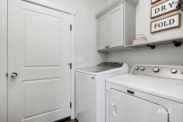 laundry room featuring cabinets and washing machine and dryer