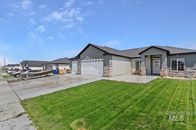 1418 N Birch St, Jerome, ID 83301 - ranch-style house with stone siding, concrete driveway, a garage, a front yard, and stucco siding