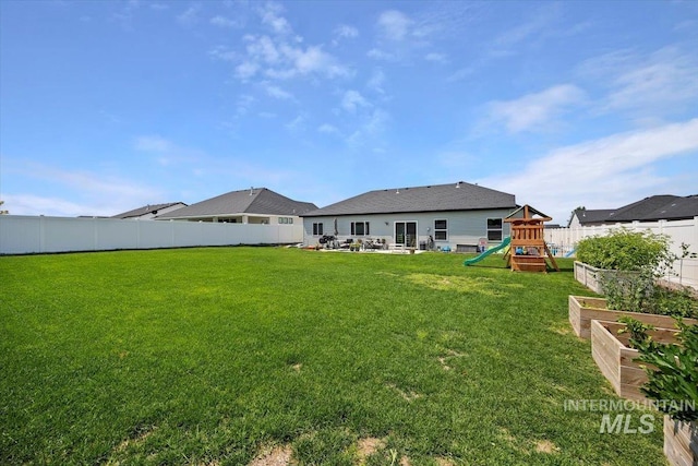 1418 N Birch St, Jerome, ID 83301 - back of house featuring a playground and a garden