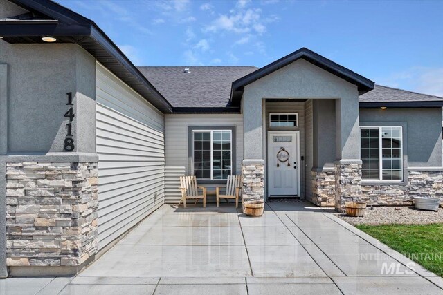 1418 N Birch St, Jerome, ID 83301 - entrance to property with stone siding, stucco siding, and roof with shingles