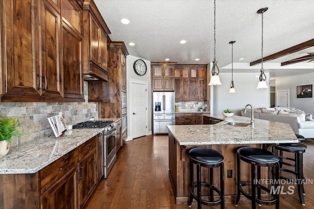 12225 W Indus Dr, Star, ID 83669 - kitchen with recessed lighting, stainless steel appliances, a large island, a sink, and a kitchen bar