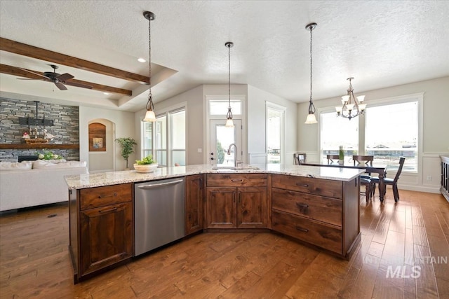 12225 W Indus Dr, Star, ID 83669 - kitchen featuring stainless steel dishwasher, dark wood-style floors, a textured ceiling, wainscoting, and light stone countertops