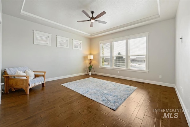 12225 W Indus Dr, Star, ID 83669 - sitting room featuring baseboards, a tray ceiling, dark wood-style floors, and ceiling fan