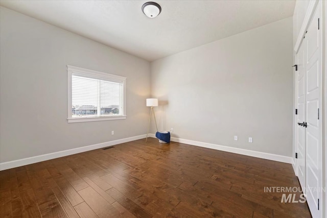 12225 W Indus Dr, Star, ID 83669 - spare room featuring baseboards, visible vents, and dark wood-style flooring