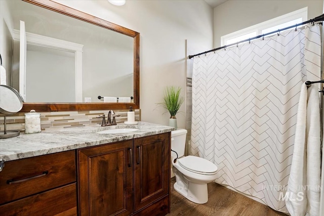 12225 W Indus Dr, Star, ID 83669 - full bathroom with toilet, a shower with curtain, vanity, and wood finished floors
