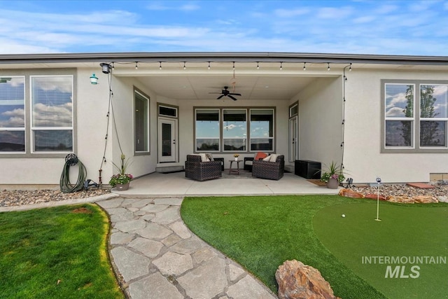 12225 W Indus Dr, Star, ID 83669 - back of property with a ceiling fan, a patio, stucco siding, and an outdoor living space
