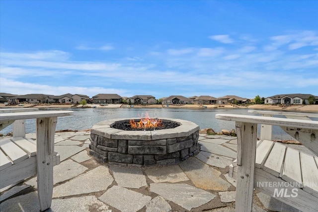 12225 W Indus Dr, Star, ID 83669 - view of patio featuring an outdoor fire pit, a residential view, and a water view
