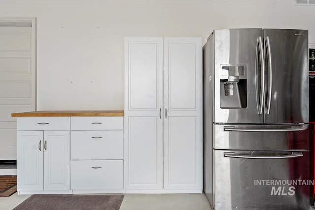 12225 W Indus Dr, Star, ID 83669 - kitchen featuring visible vents, stainless steel refrigerator with ice dispenser, and white cabinetry