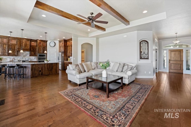 12225 W Indus Dr, Star, ID 83669 - living area featuring ceiling fan, arched walkways, dark wood-style floors, and baseboards
