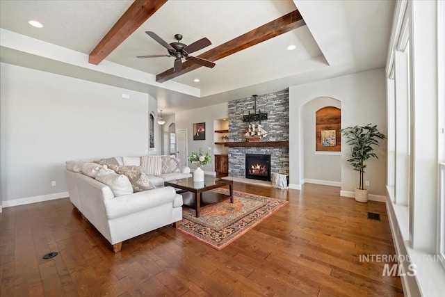 12225 W Indus Dr, Star, ID 83669 - living area with hardwood / wood-style flooring, ceiling fan, arched walkways, and baseboards