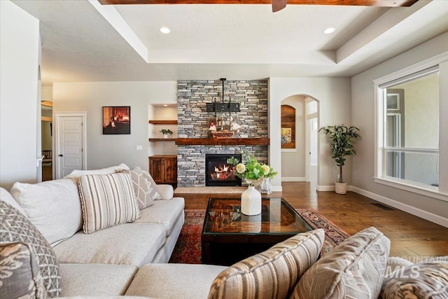 12225 W Indus Dr, Star, ID 83669 - living area featuring arched walkways, a raised ceiling, hardwood / wood-style floors, and baseboards