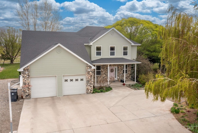 traditional-style house with a shingled roof, stone siding, a garage, a porch, and driveway