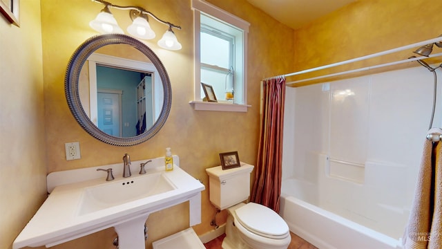 bathroom featuring a sink, baseboards, toilet, and shower / bath combination with curtain