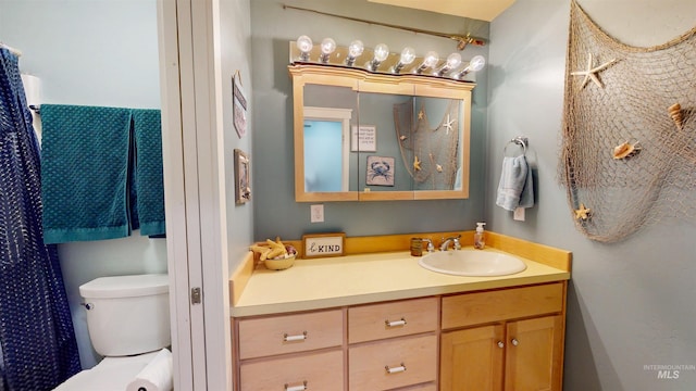 bathroom featuring vanity and toilet