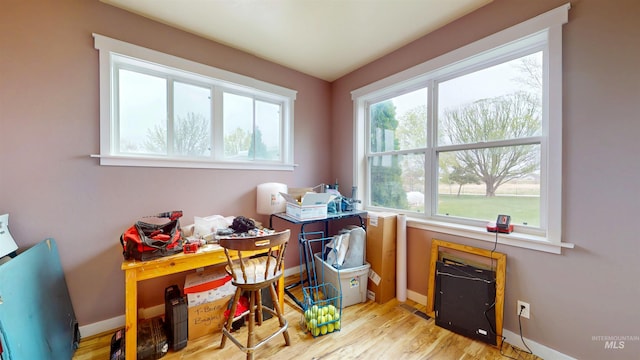 office space with baseboards and wood finished floors