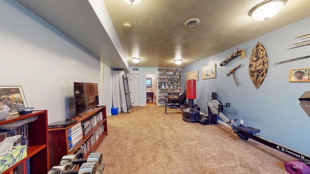 interior space featuring carpet flooring, a textured ceiling, visible vents, and baseboards