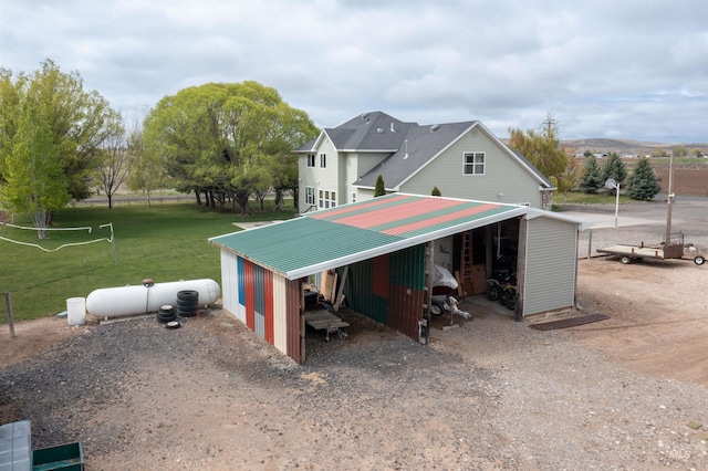 view of pole building featuring a lawn and dirt driveway