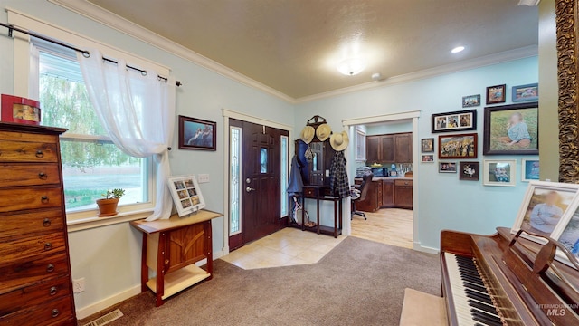 entryway with visible vents, ornamental molding, baseboards, and light colored carpet