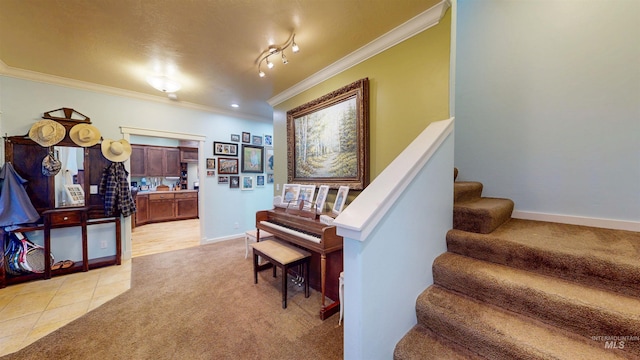 stairway featuring crown molding, tile patterned floors, carpet, and baseboards