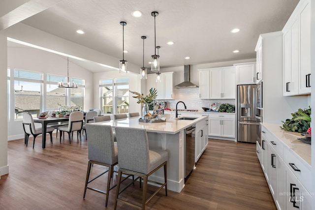 1210 Stirling Meadows Ct, Middleton, ID 83644 - kitchen with wall chimney exhaust hood, appliances with stainless steel finishes, a breakfast bar, recessed lighting, and backsplash
