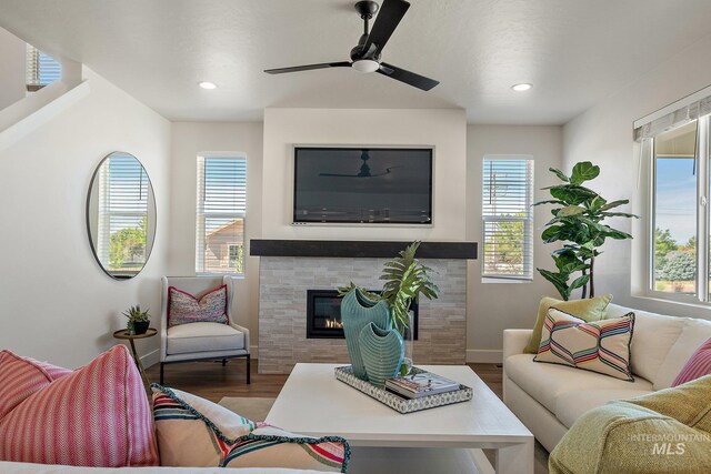 1210 Stirling Meadows Ct, Middleton, ID 83644 - living room with wood finished floors, a tiled fireplace, recessed lighting, a ceiling fan, and baseboards