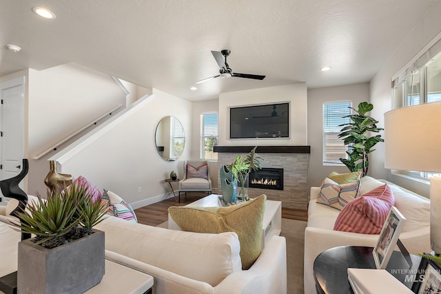 1210 Stirling Meadows Ct, Middleton, ID 83644 - living area featuring a ceiling fan, recessed lighting, a tiled fireplace, wood finished floors, and baseboards