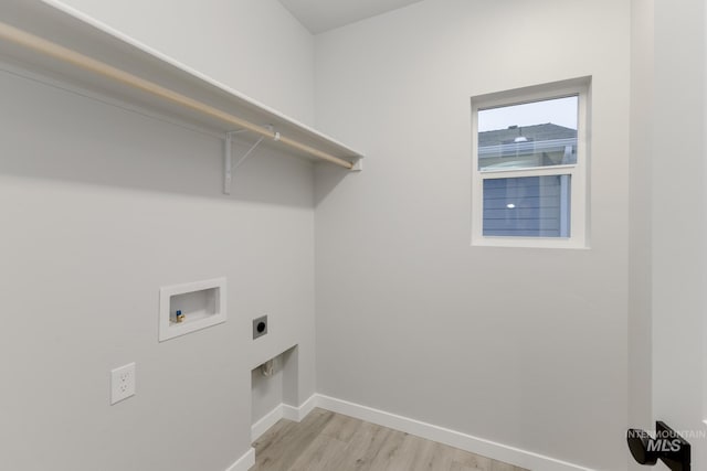 clothes washing area with washer hookup, hookup for an electric dryer, light wood-type flooring, laundry area, and baseboards