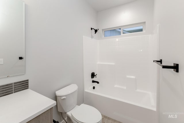 bathroom featuring tub / shower combination, vanity, and toilet