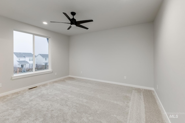 carpeted spare room with ceiling fan, recessed lighting, visible vents, and baseboards