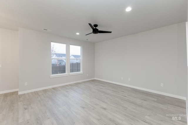 unfurnished room featuring recessed lighting, light wood-type flooring, and baseboards