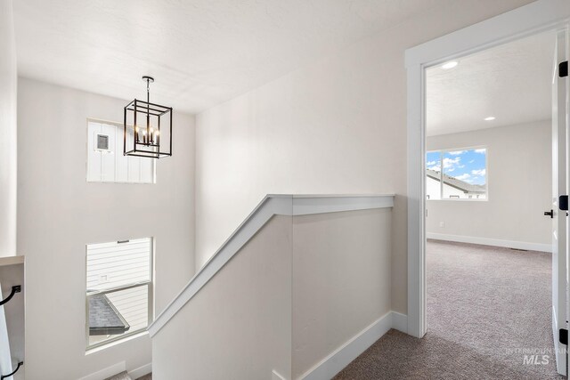 6080 N Senita Hills Ave, Meridian, ID 83646 - staircase featuring carpet floors, baseboards, and a chandelier