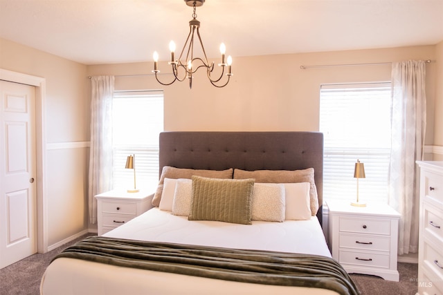 carpeted bedroom with an inviting chandelier