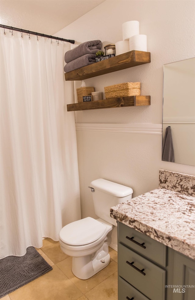 bathroom with tile patterned floors, vanity, and toilet