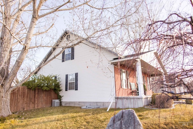 view of home's exterior featuring a yard and central AC