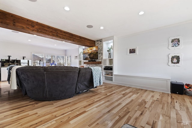 living room featuring recessed lighting, ornamental molding, wood finished floors, and beamed ceiling