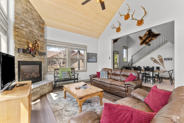 1089 Graham Dr, Mccall, ID 83638 - living room featuring hardwood / wood-style flooring, ceiling fan, wooden ceiling, high vaulted ceiling, and stairs