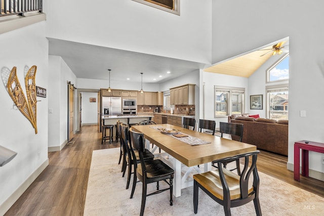 1089 Graham Dr, Mccall, ID 83638 - dining room with high vaulted ceiling, a ceiling fan, baseboards, light wood-type flooring, and recessed lighting