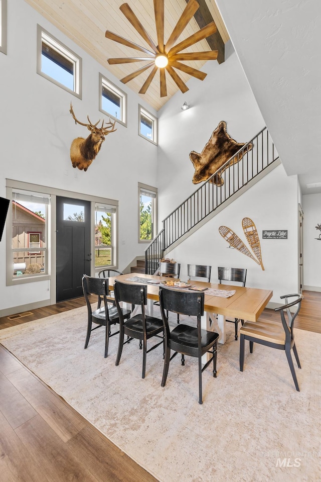 1089 Graham Dr, Mccall, ID 83638 - dining area featuring a towering ceiling, stairway, wood finished floors, ceiling fan, and beam ceiling