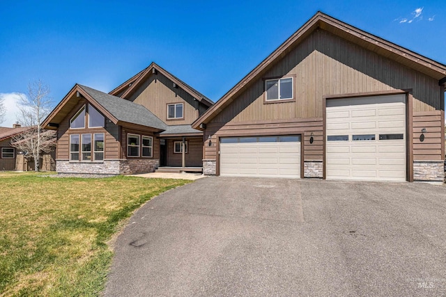 1089 Graham Dr, Mccall, ID 83638 - view of front of home with stone siding, a garage, a front lawn, and driveway