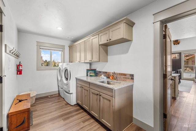 1089 Graham Dr, Mccall, ID 83638 - laundry area featuring cabinet space, washing machine and dryer, light wood finished floors, baseboards, and recessed lighting