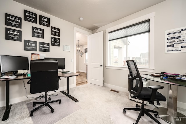 carpeted office with baseboards and visible vents