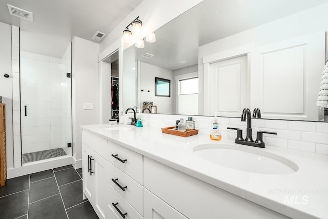 full bathroom with a sink, visible vents, a shower stall, and tile patterned floors