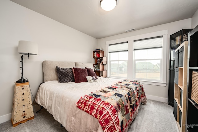 bedroom with visible vents, baseboards, and carpet