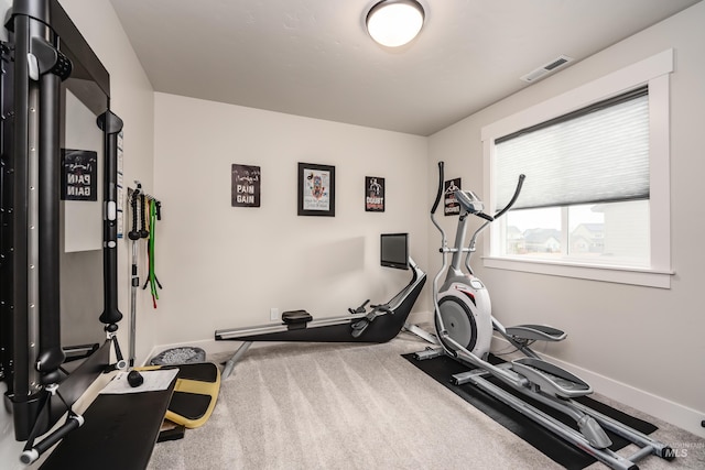 exercise area with baseboards, visible vents, and carpet floors